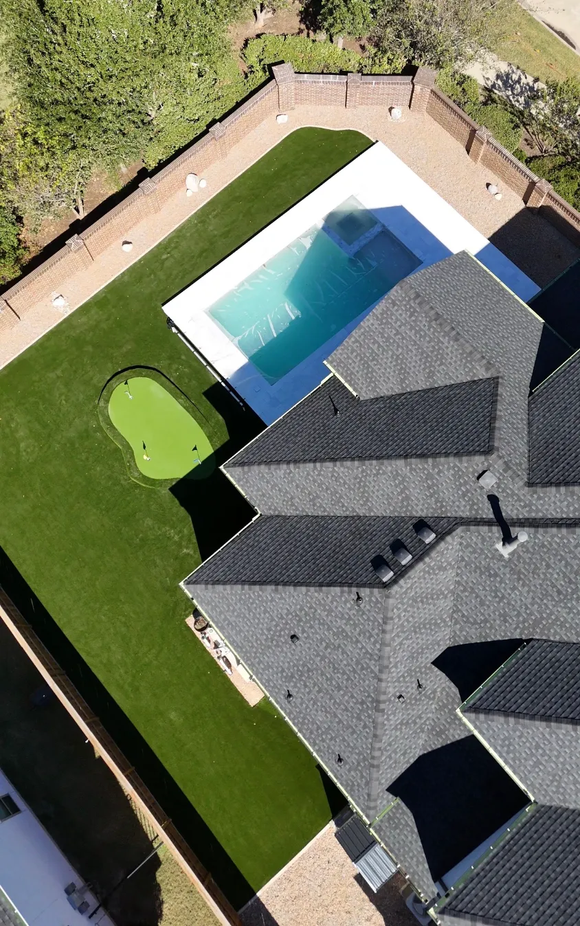 Pet-friendly synthetic turf yard with permeable drainage backing