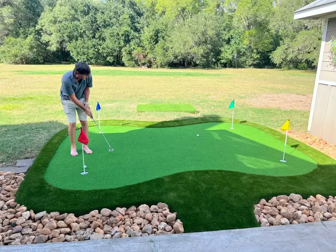 Custom backyard putting green built with tournament-grade nylon turf